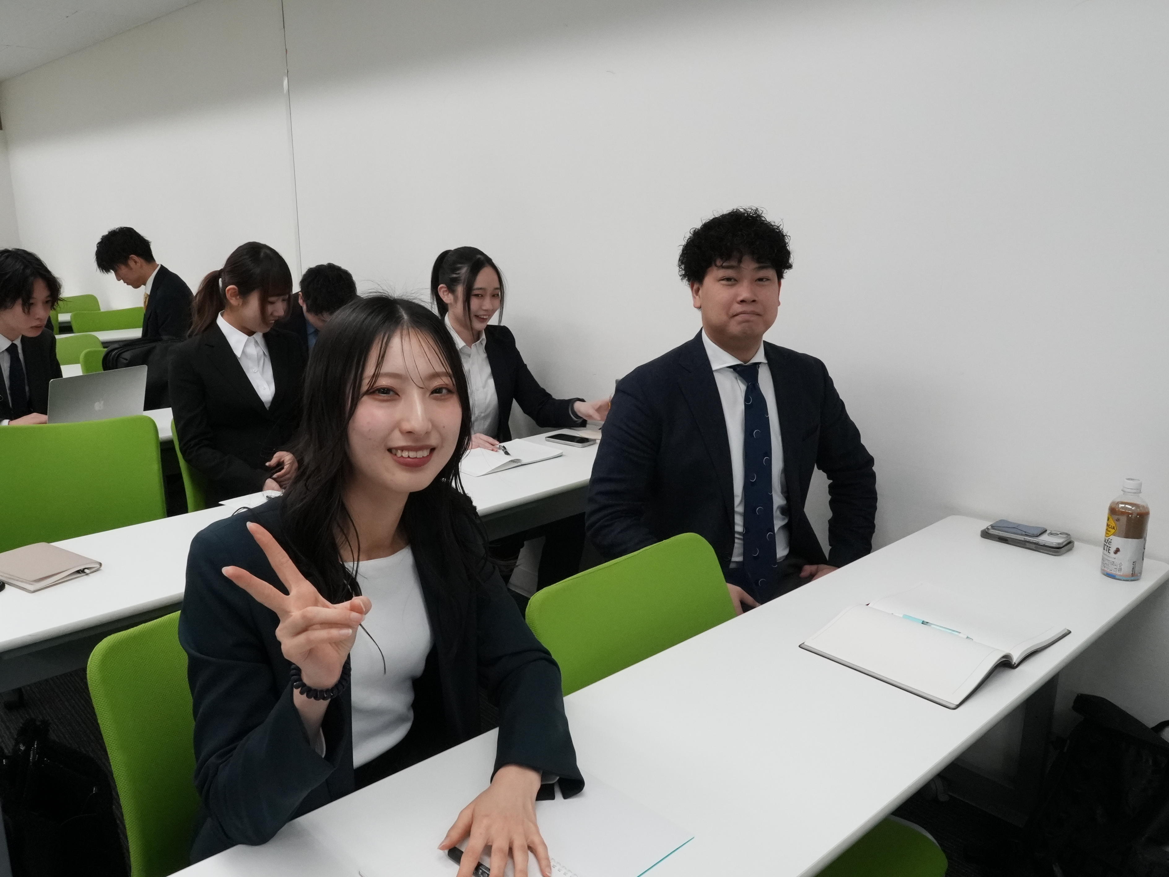 オフィスで笑顔で学ぶ若手社員の様子